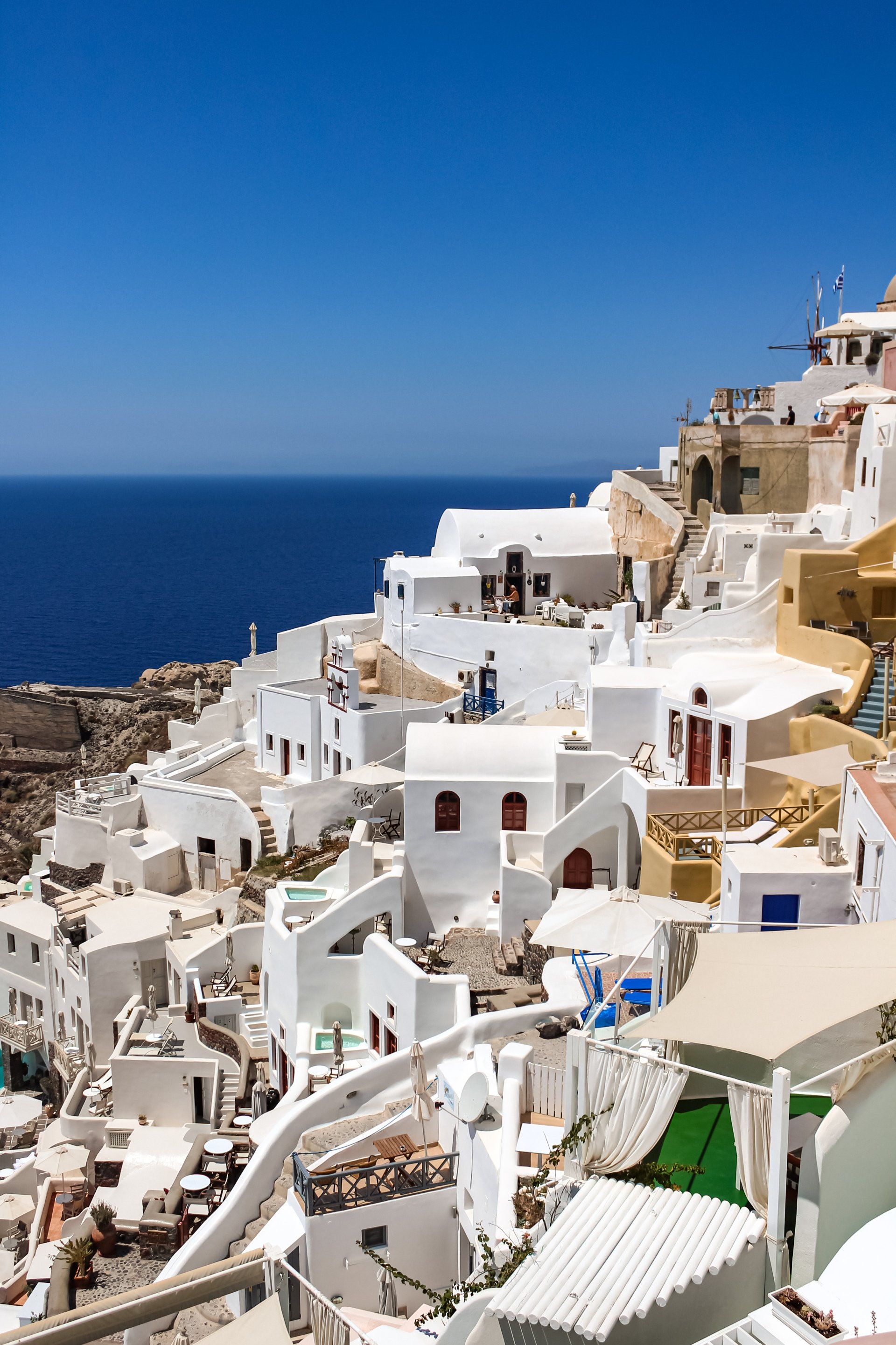 A row of white houses on a hill overlooking the ocean