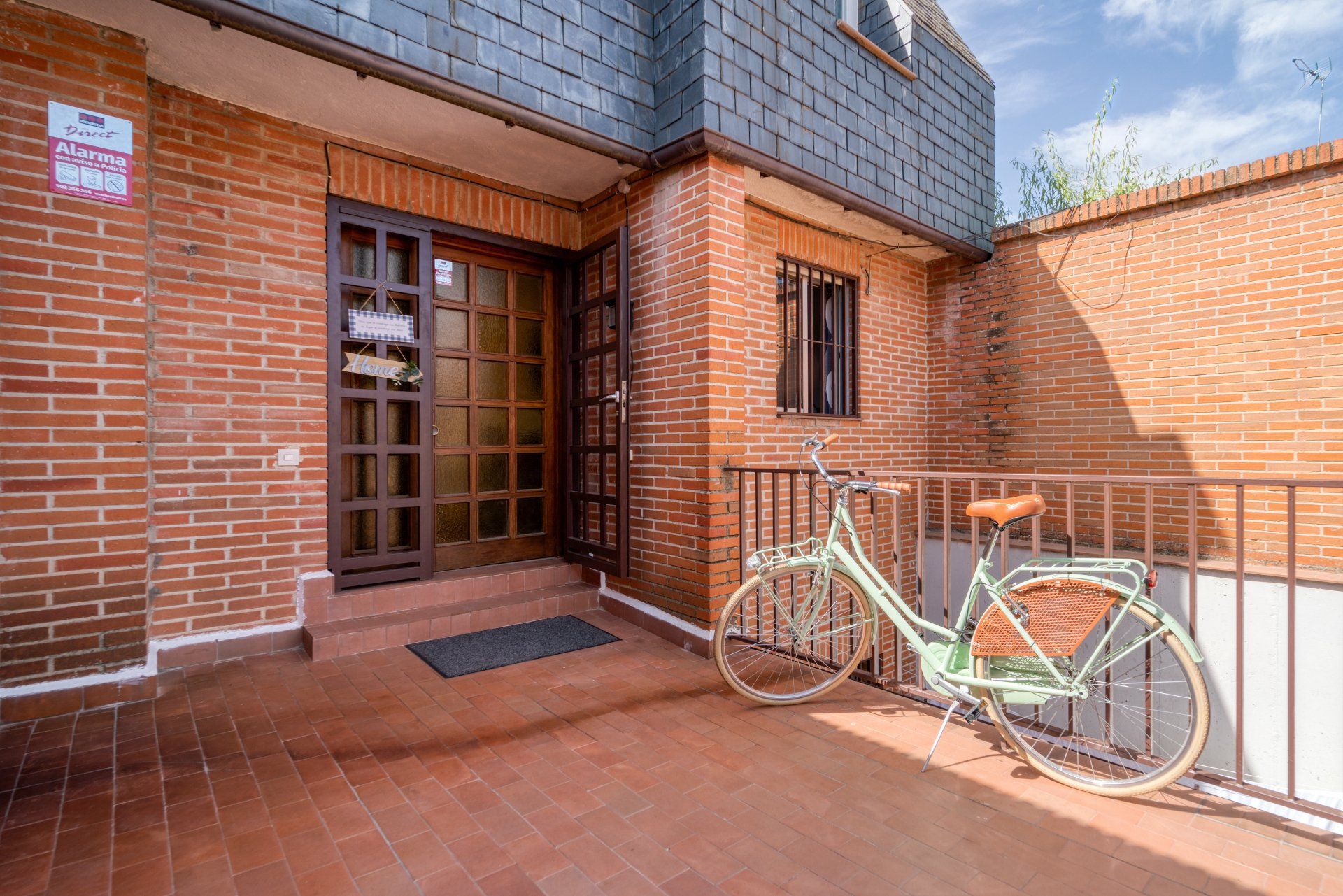 A bicycle is parked in front of a brick building.