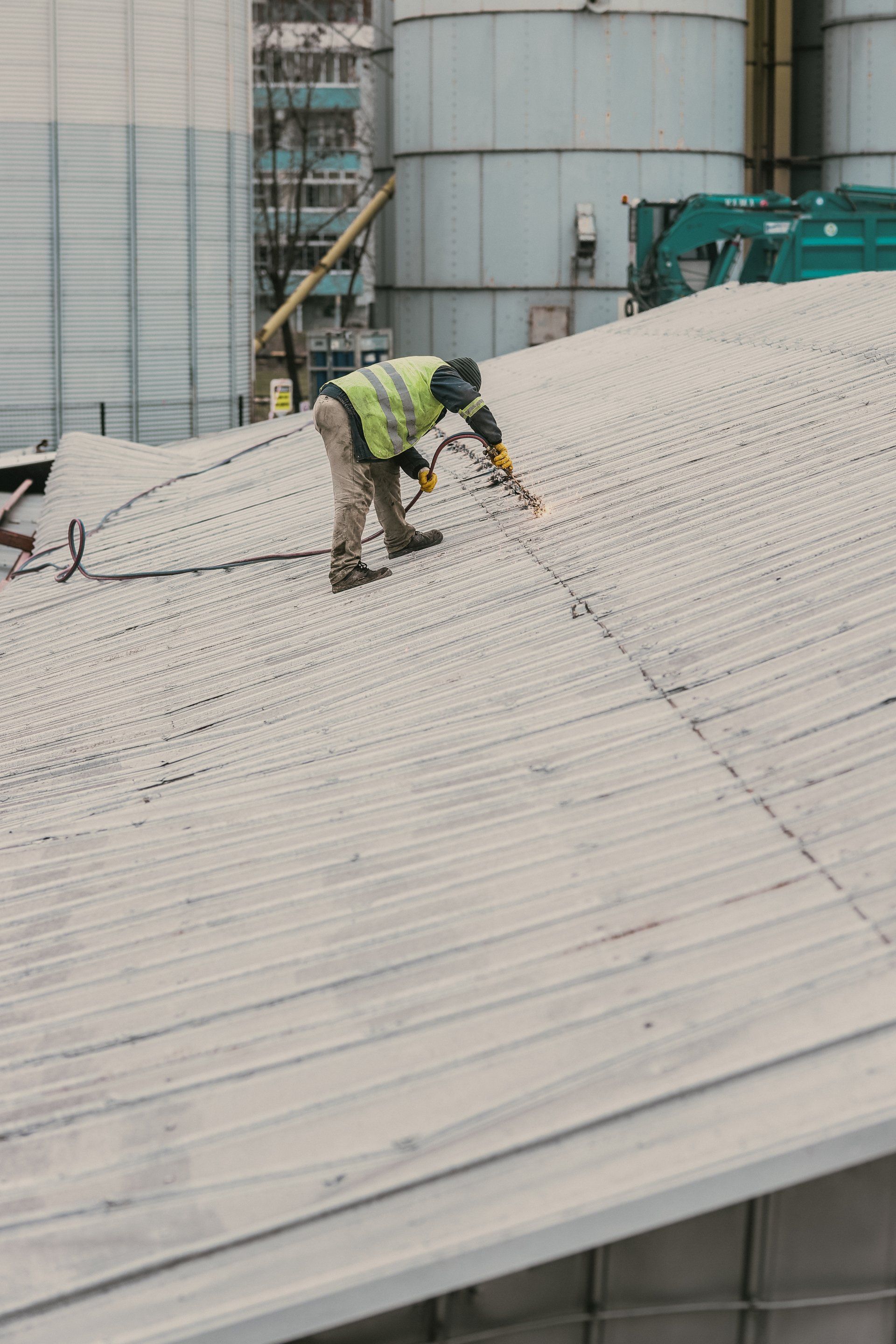 a roofer fixing the roof