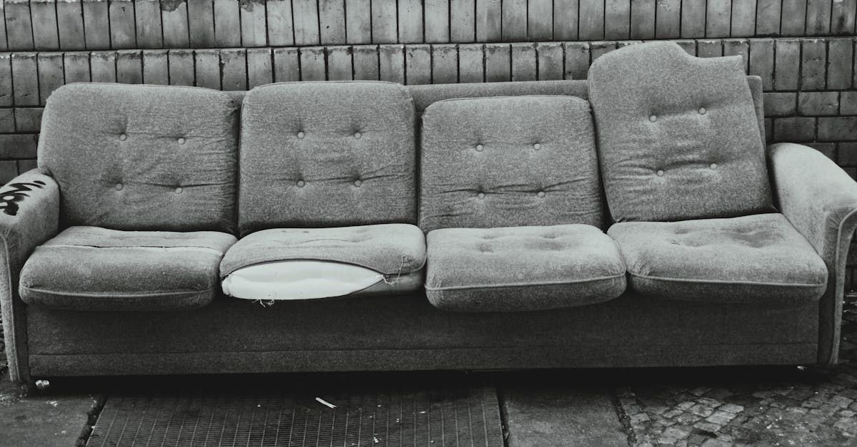 A black and white photo of an old couch