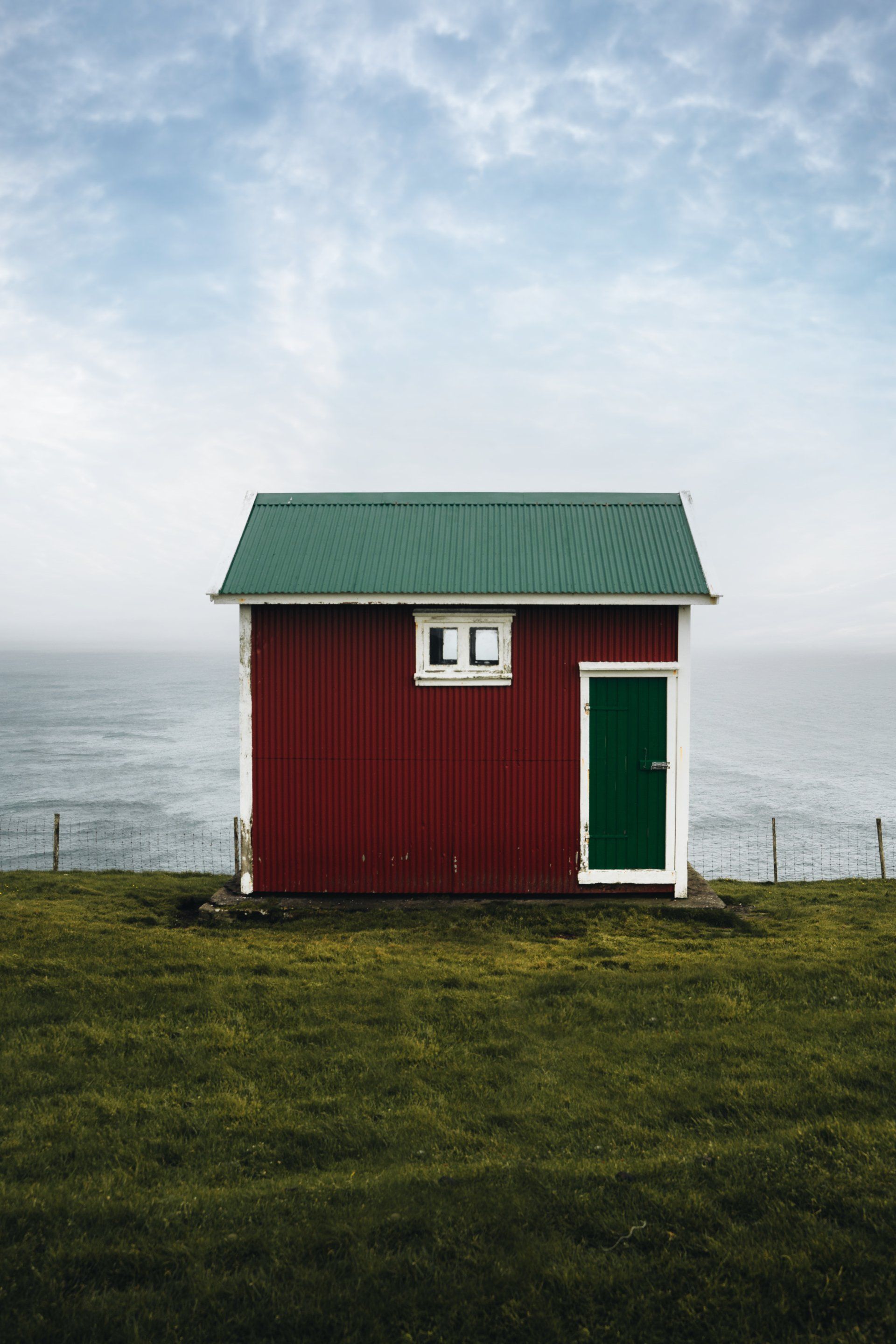 a red house with green roof