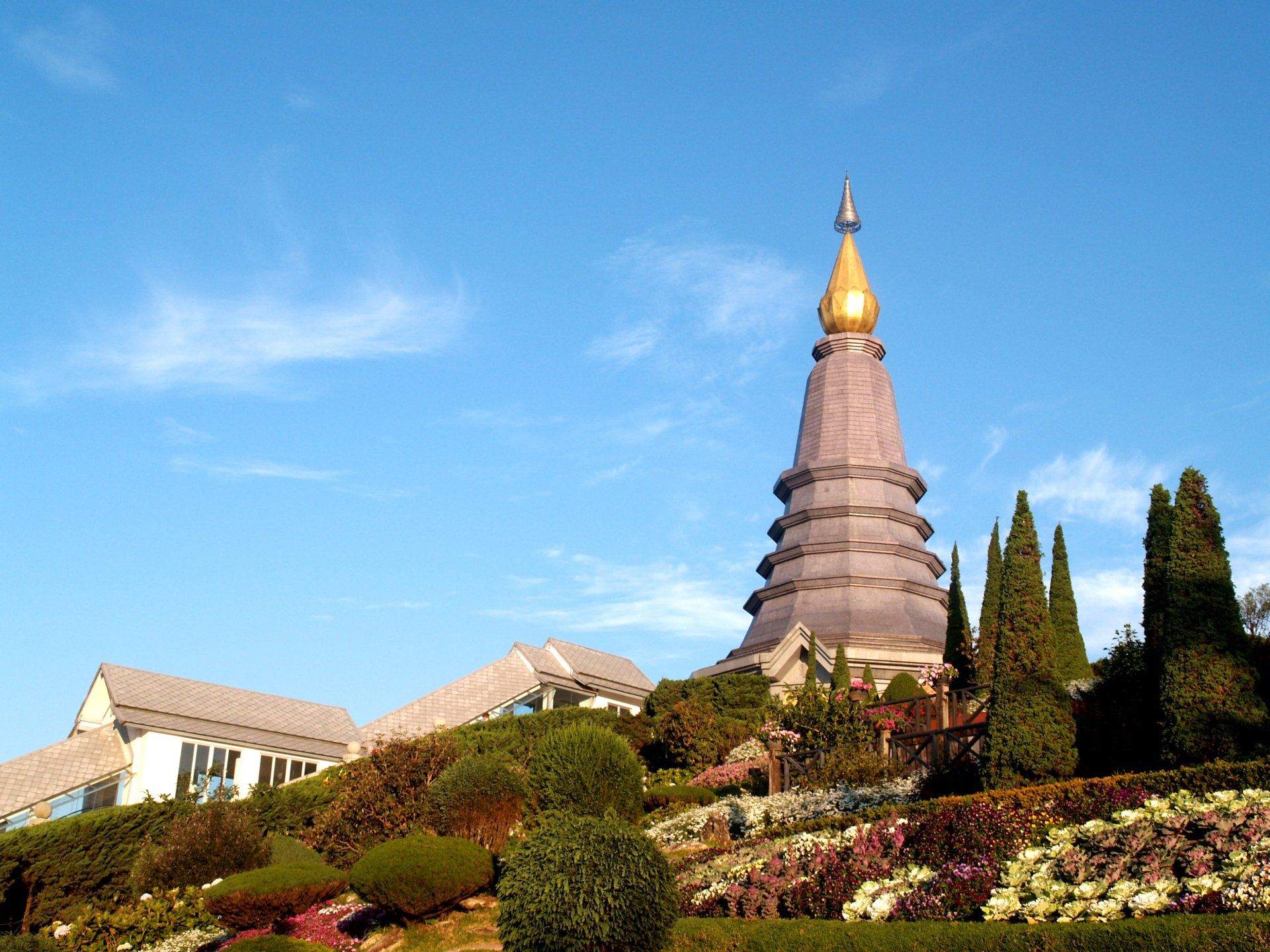 A very tall building on top of a hill with a blue sky in the background