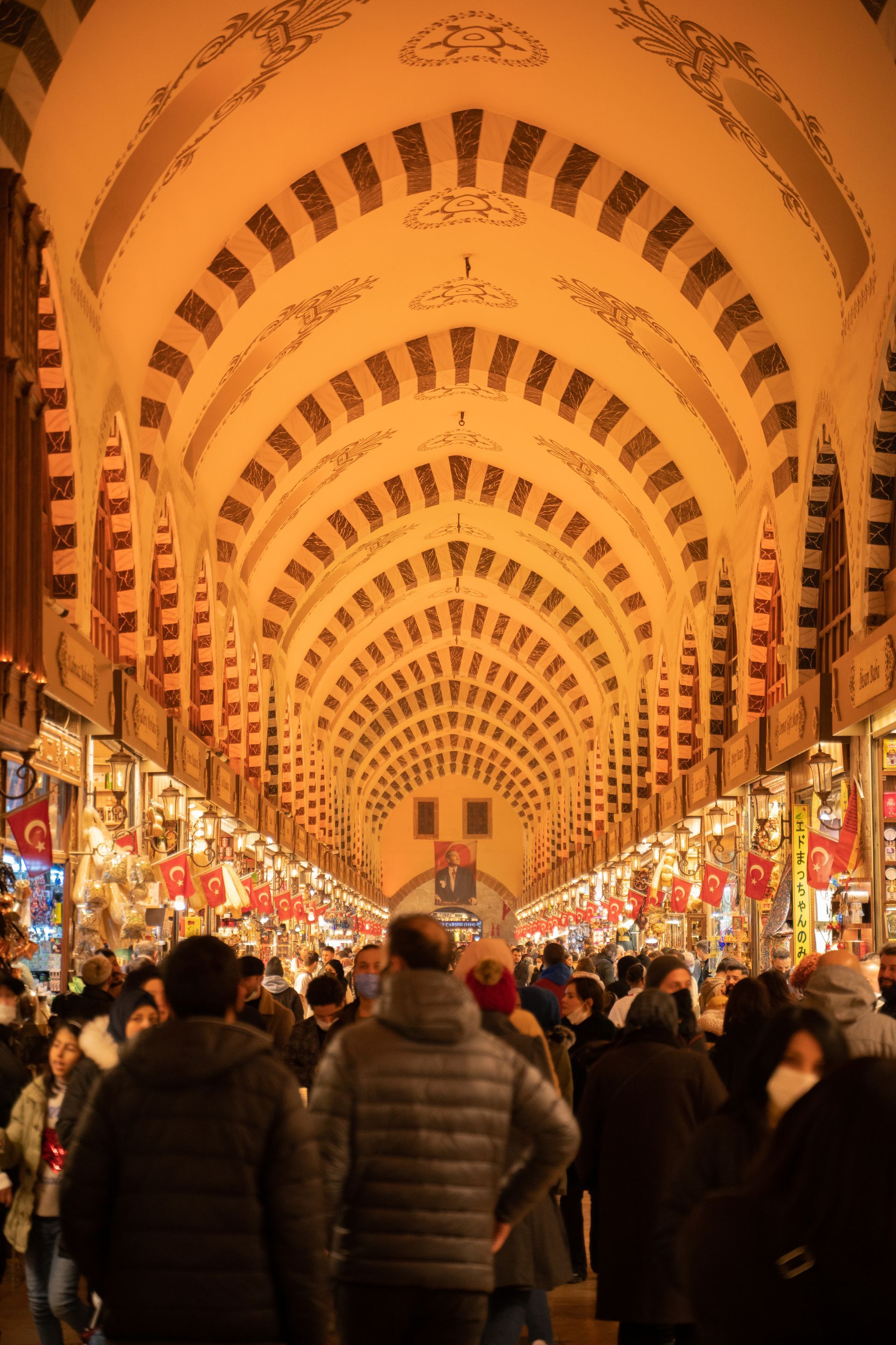 A crowd of people are walking through a busy market.