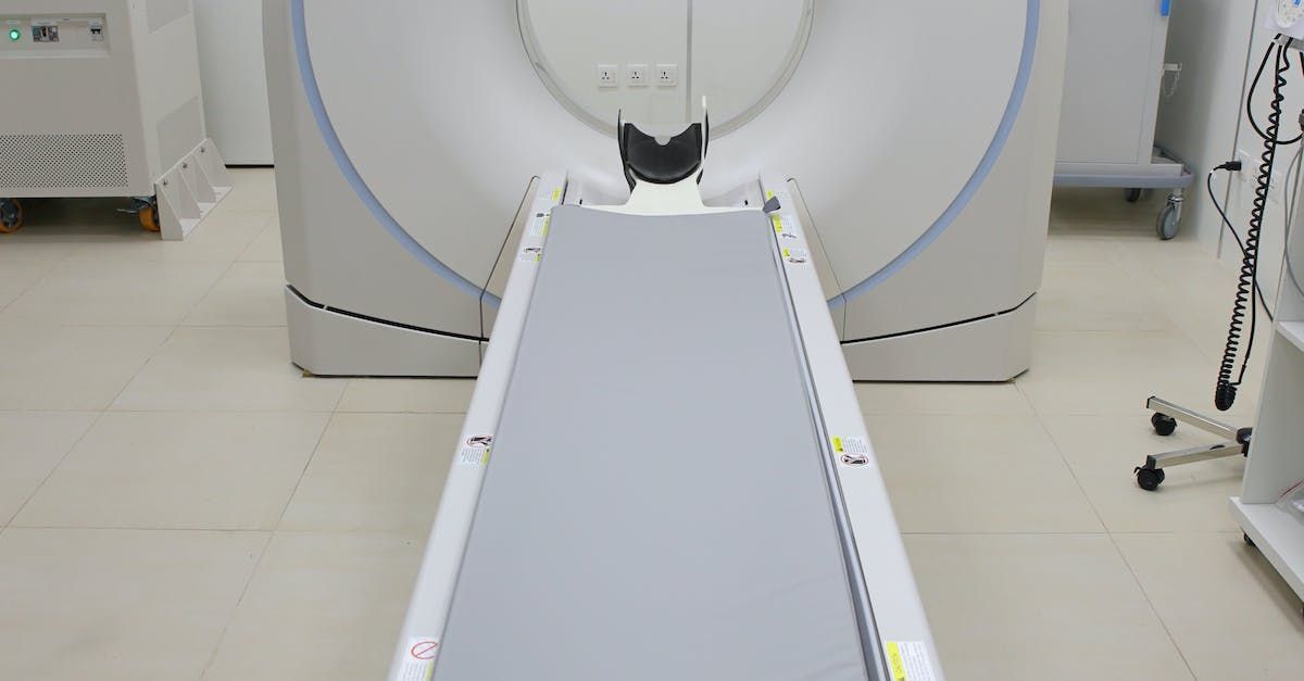 A ct scan machine is sitting in a hospital room.
