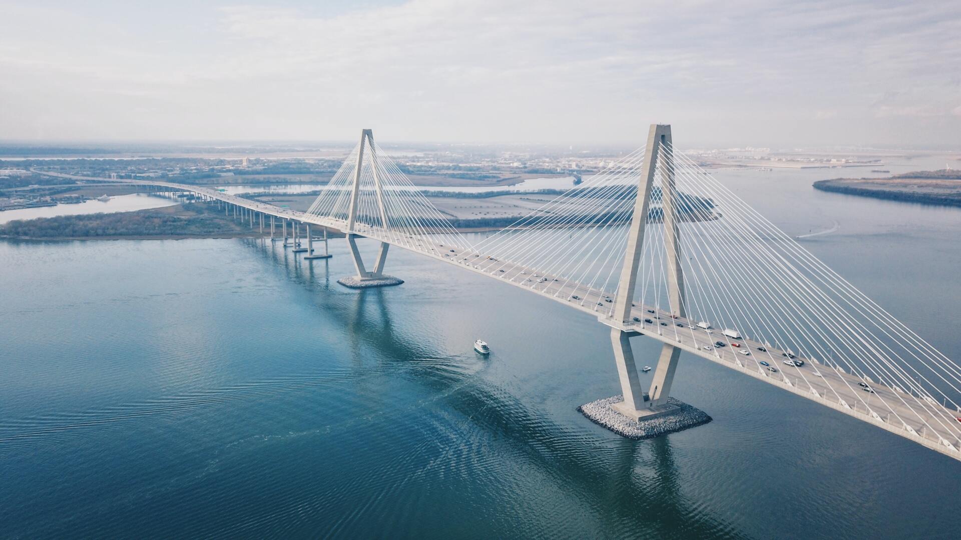 An aerial view of a bridge over a body of water.