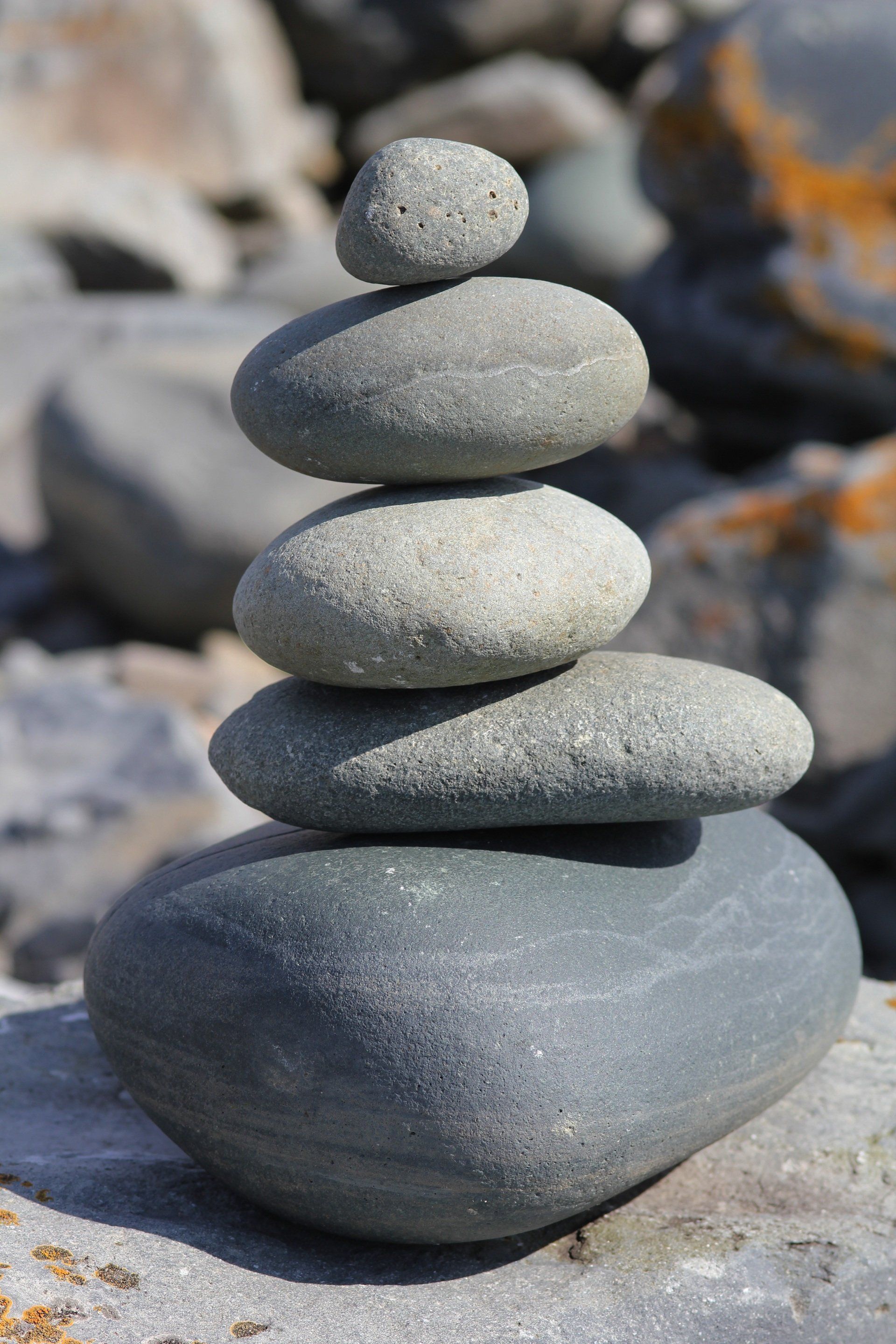 A pile of rocks stacked on top of each other on a rocky beach.