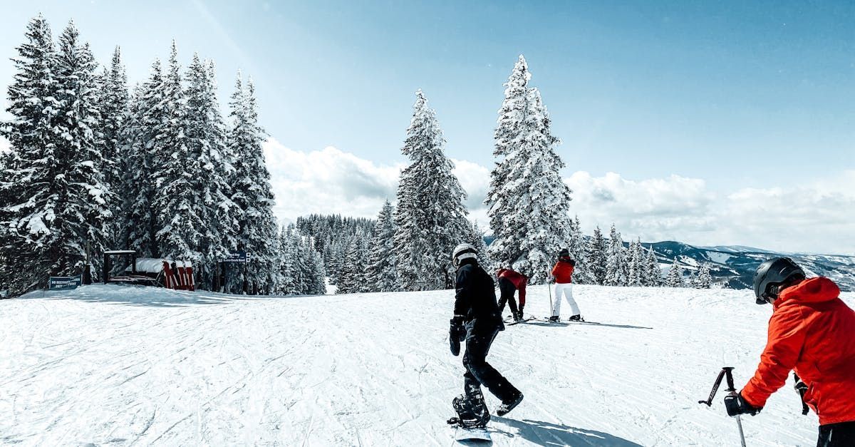 A group of people are skiing down a snow covered slope.