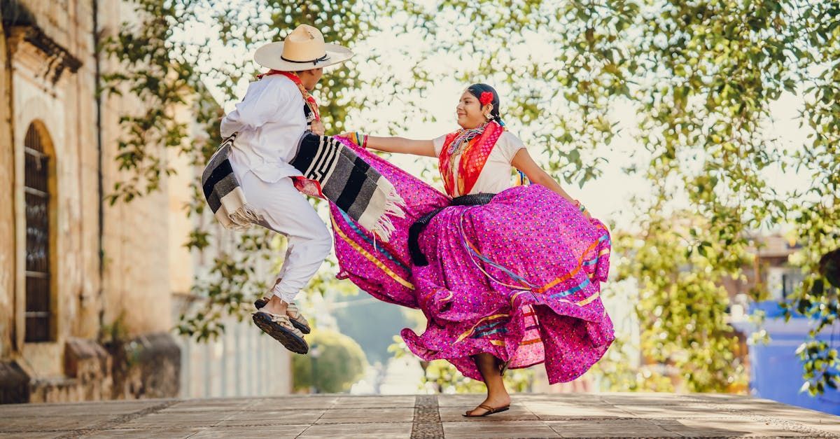 A man and a woman are dancing in a traditional mexican dress.