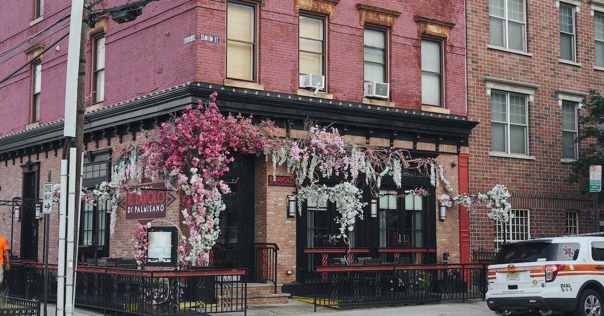 A police car is parked in front of a brick building.