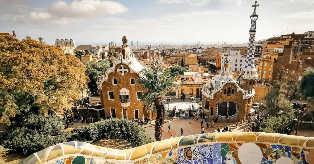 A view of a city from a balcony with a tower in the background.