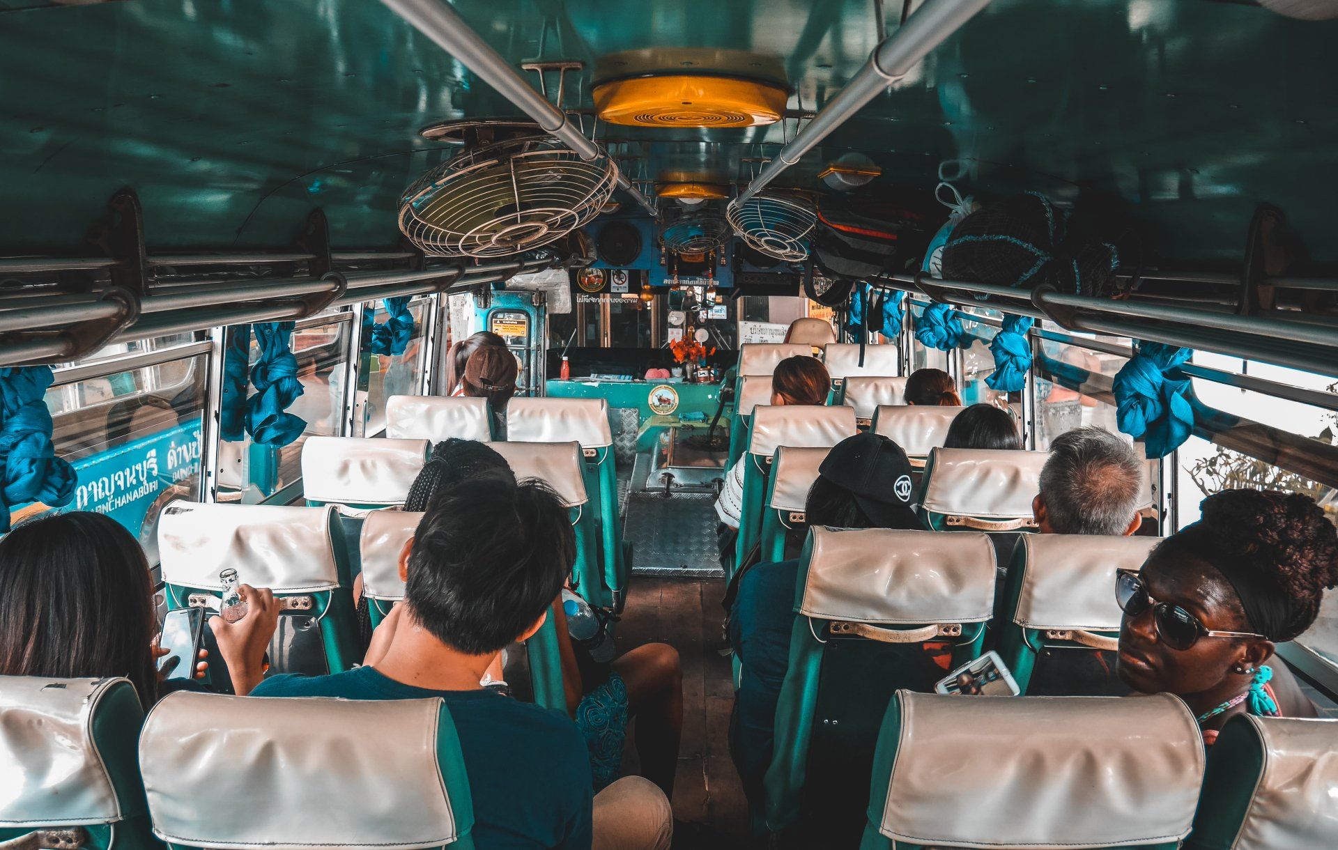 Group of friends enjoying a ride together inside a San Diego charter bus during a group trip