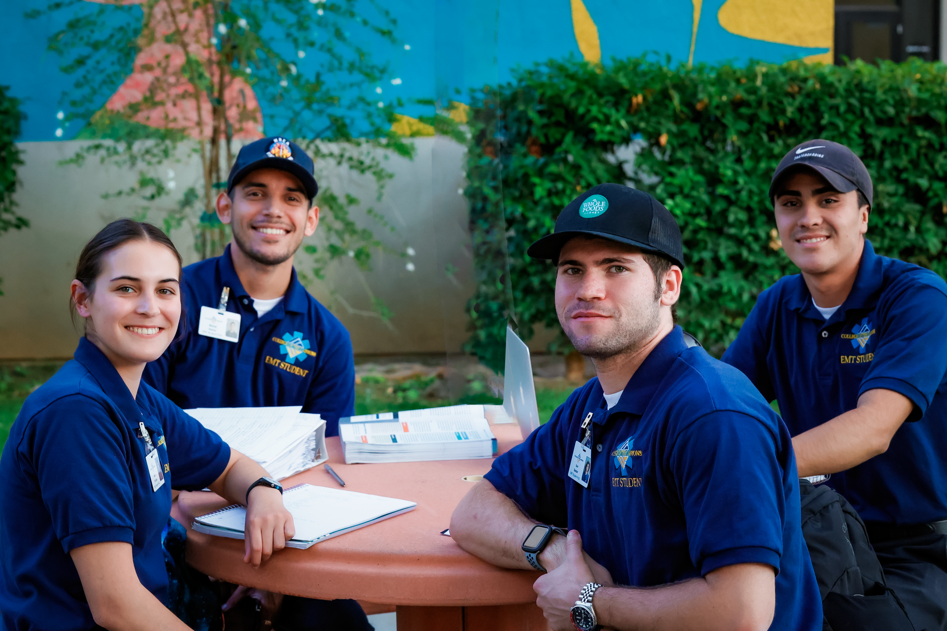 a group of people are posing for a picture while sitting around a table .