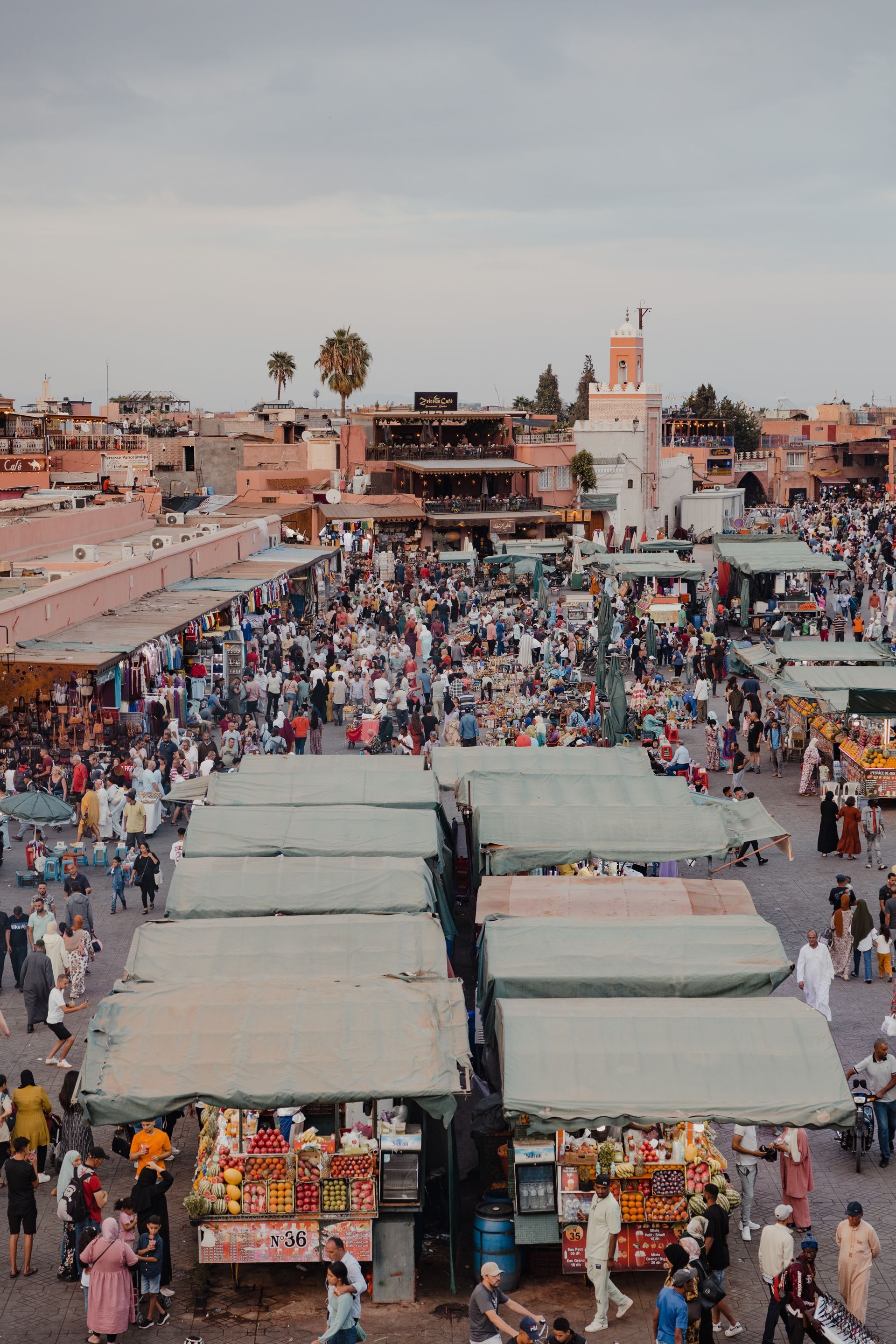 An aerial view of a crowded market in a city.