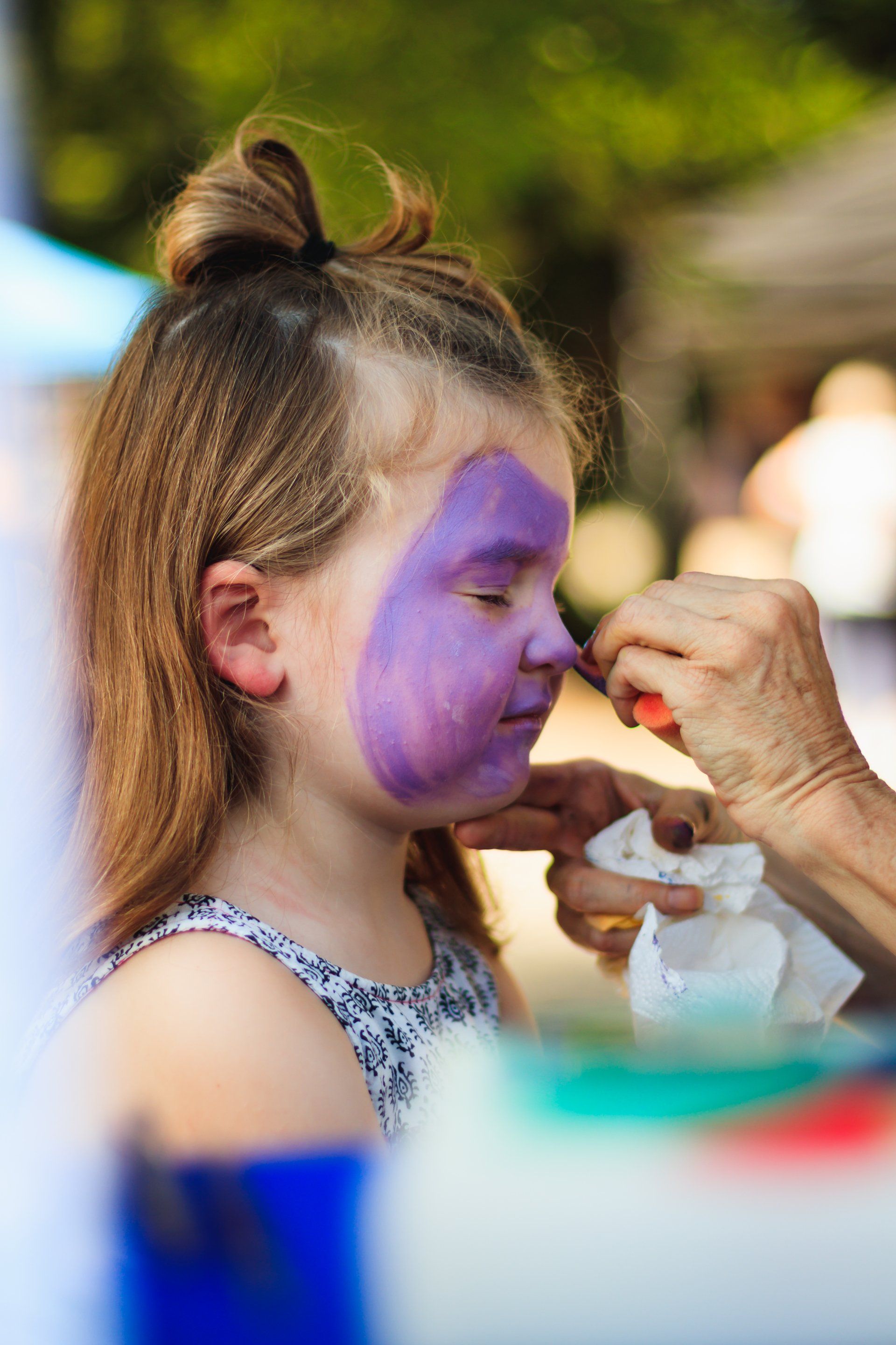 Little girl getting her face painted