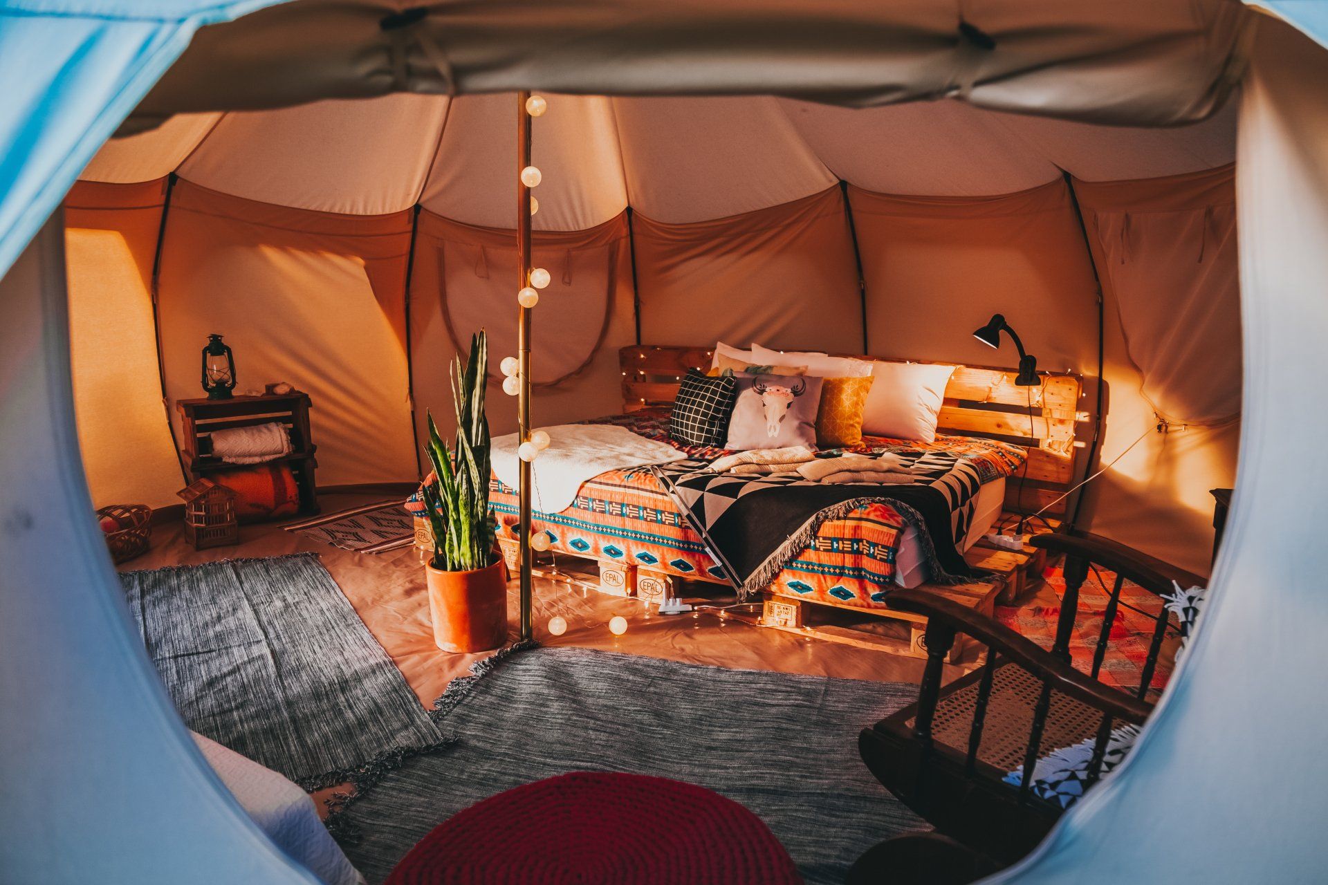 glamping tent with bed and cozy accommodations