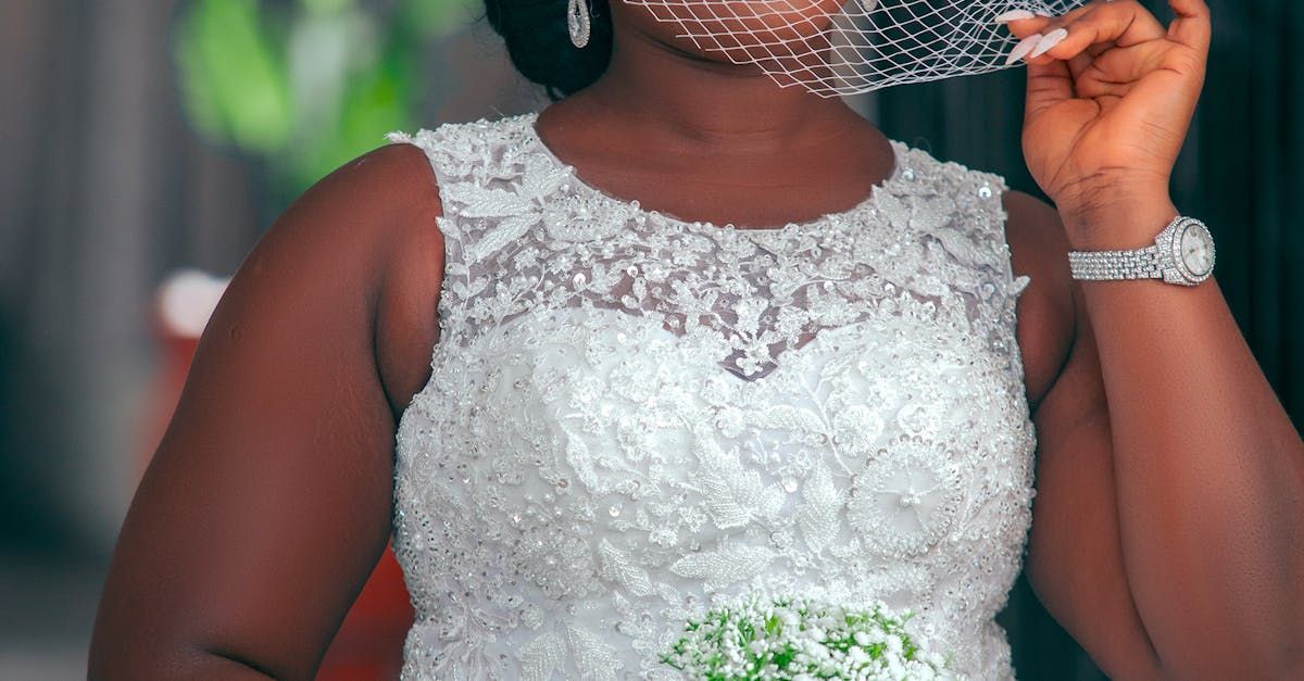 woman standing with flowers in hand and in wedding dress