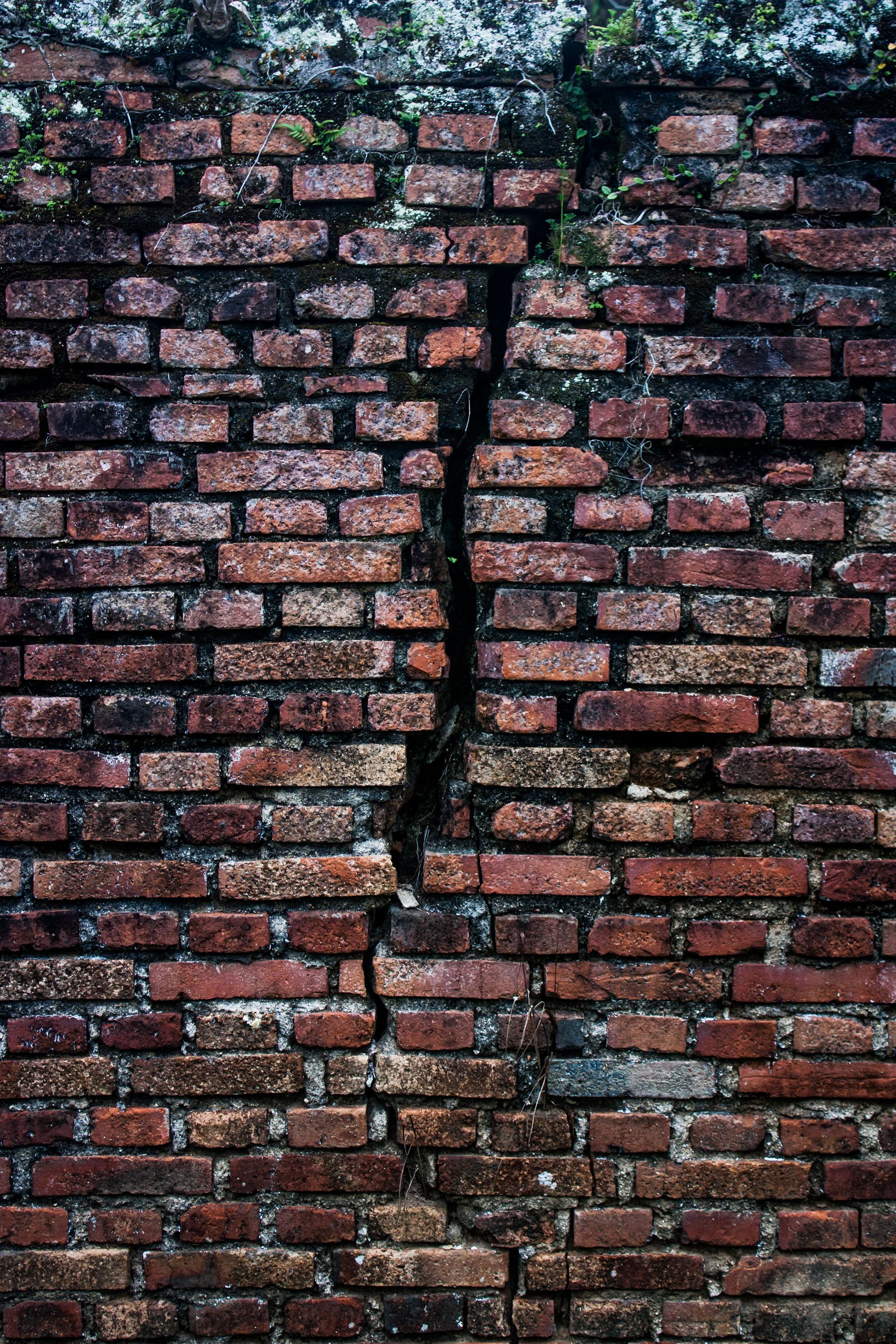 cracked brick wall of home