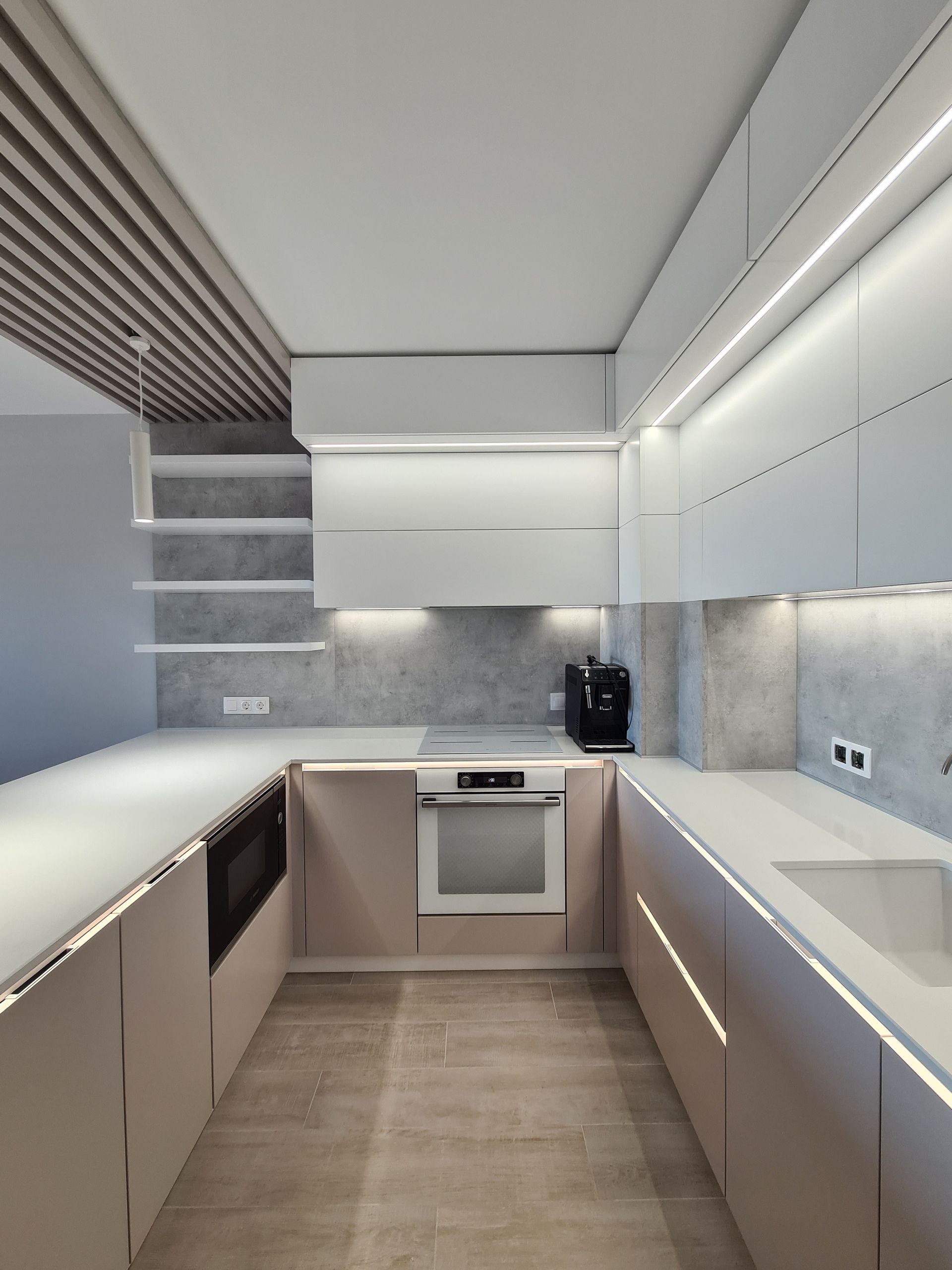 A kitchen with white cabinets and a stove top oven