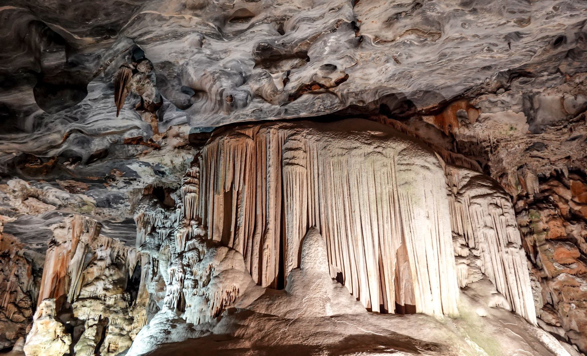 A cave with a waterfall in the middle of it