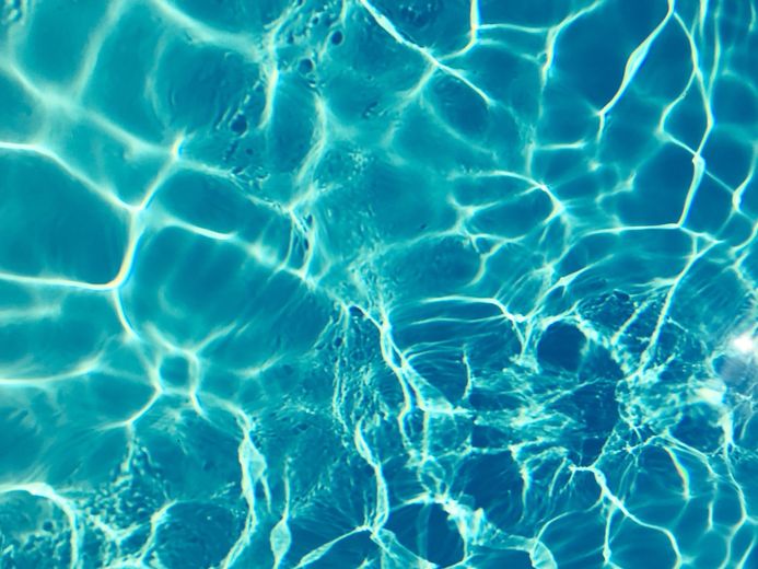 A close up of the water in a swimming pool