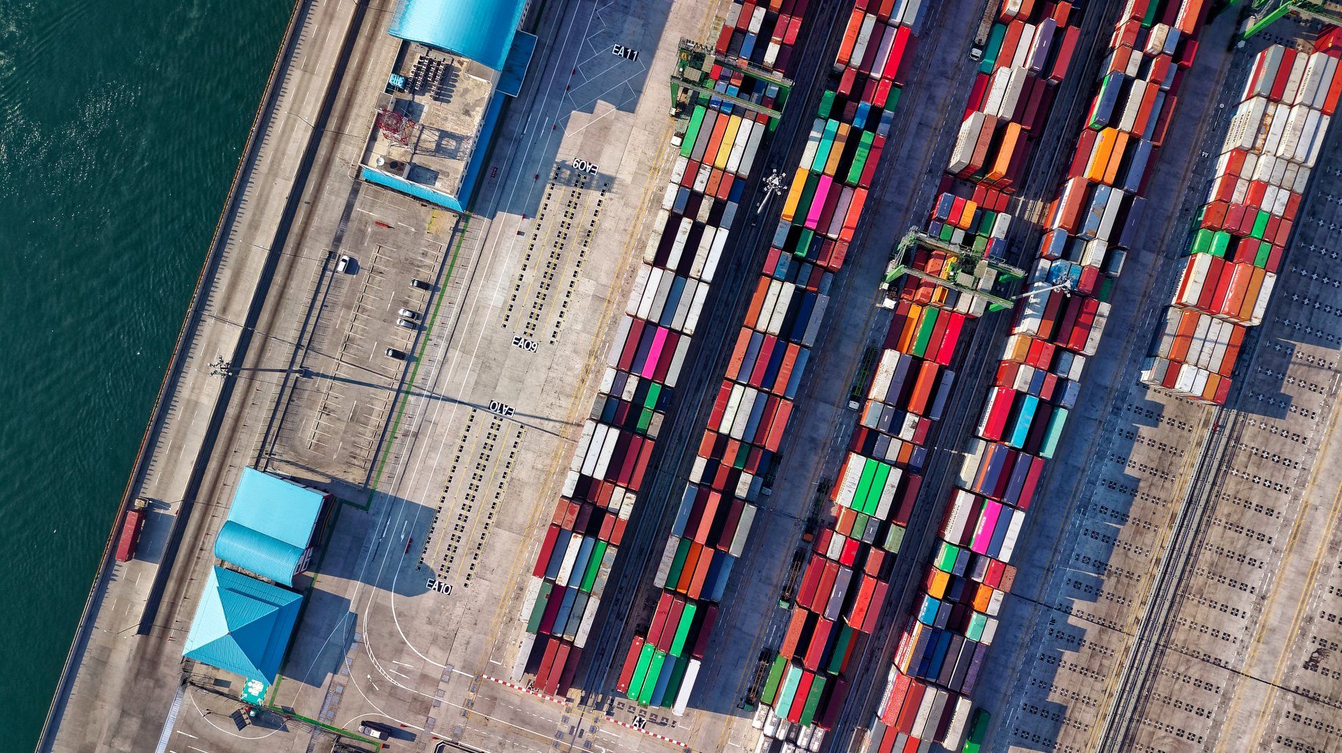 An aerial view of a dock filled with lots of containers.