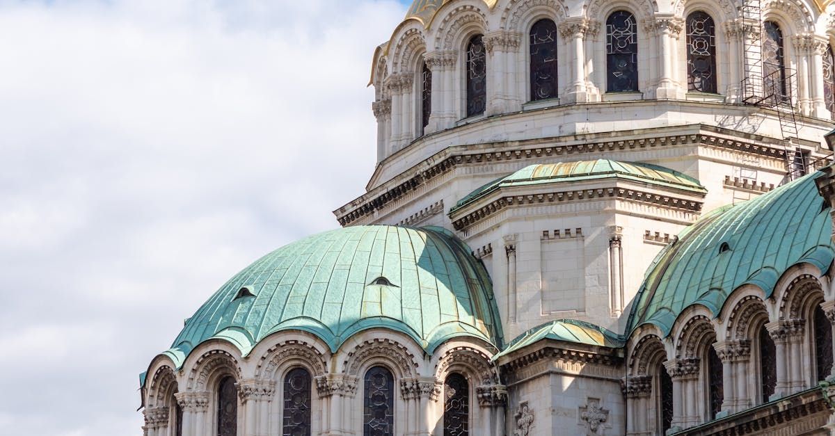 A large building with a green dome on top of it.