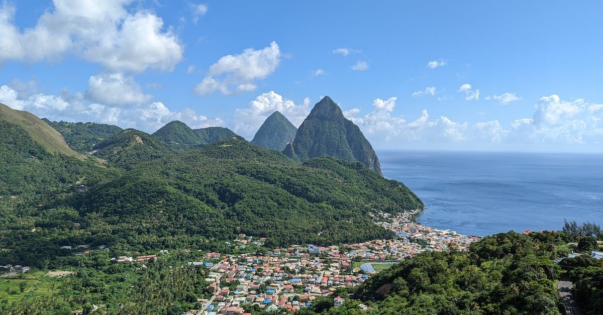 A view of a small town surrounded by mountains and a body of water.