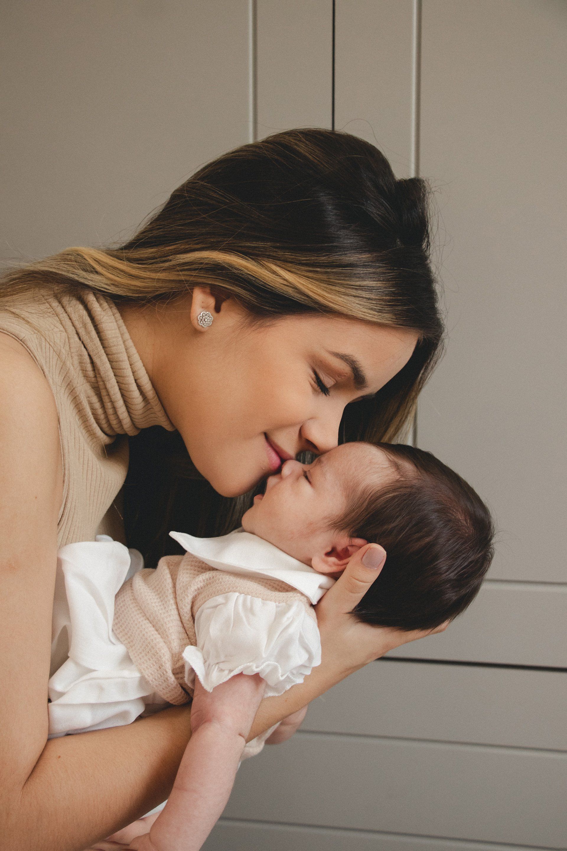 Mom kissing a baby