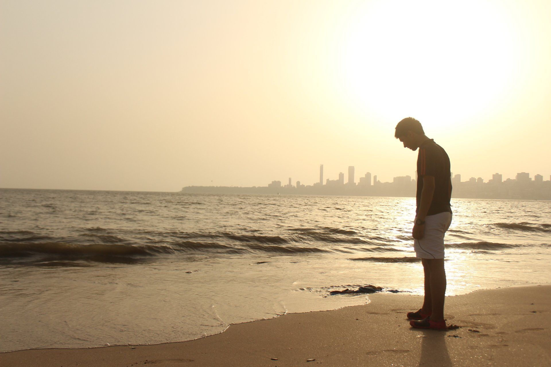 Man at the beach at sunset