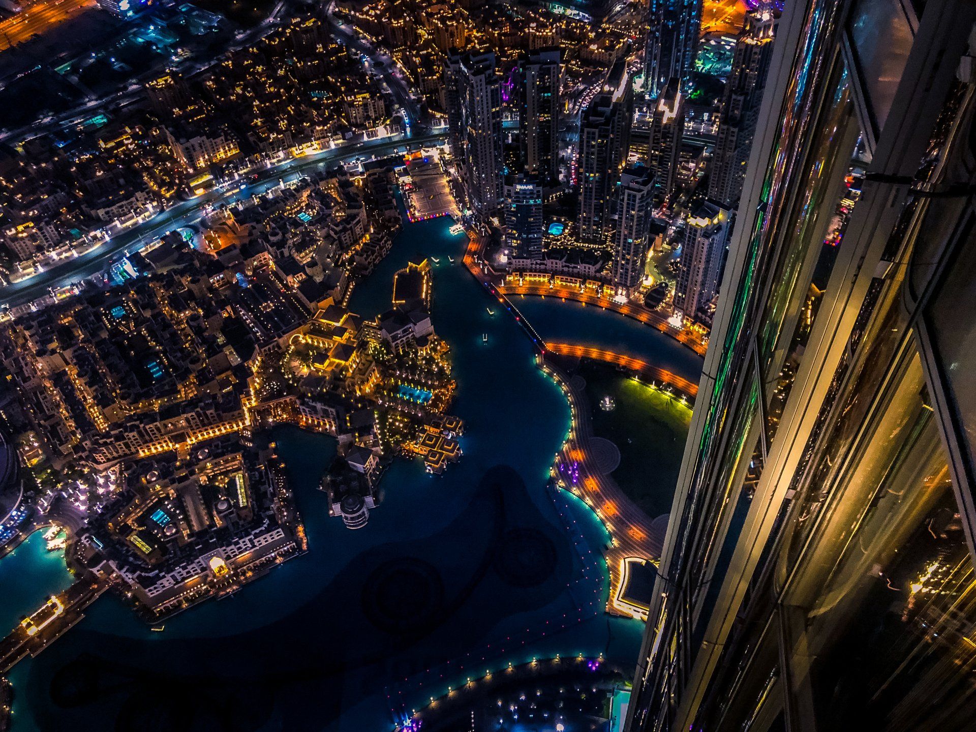 An aerial view of a city at night from the top of a building.