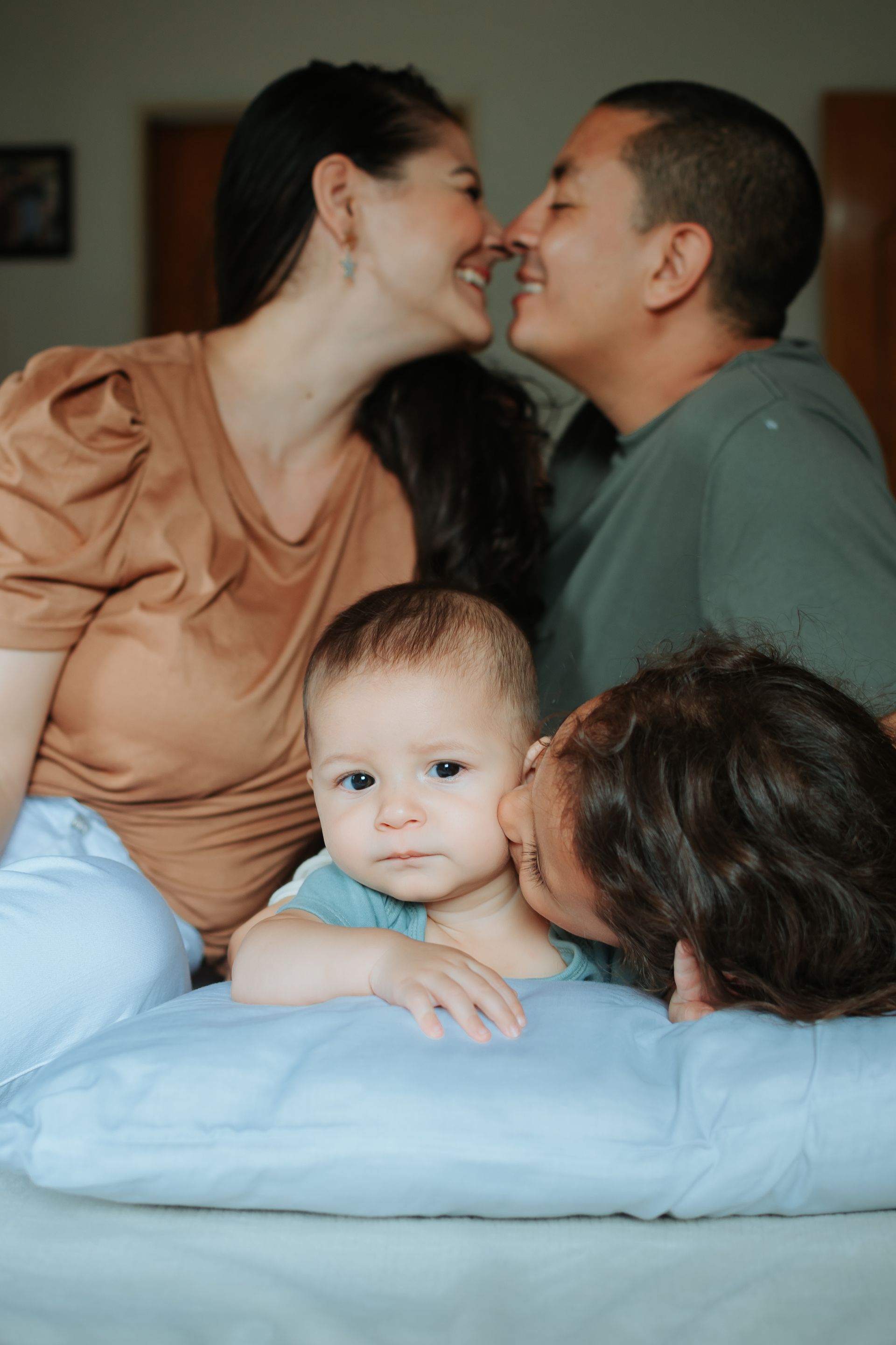 Mom and Dad with their baby. Smiling.