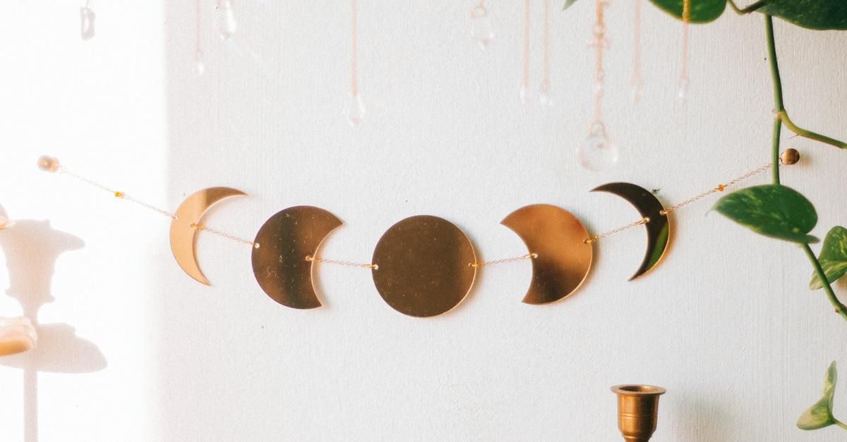 shapes of the different phases of the moon, made of copper, strung on a chain as decor. 