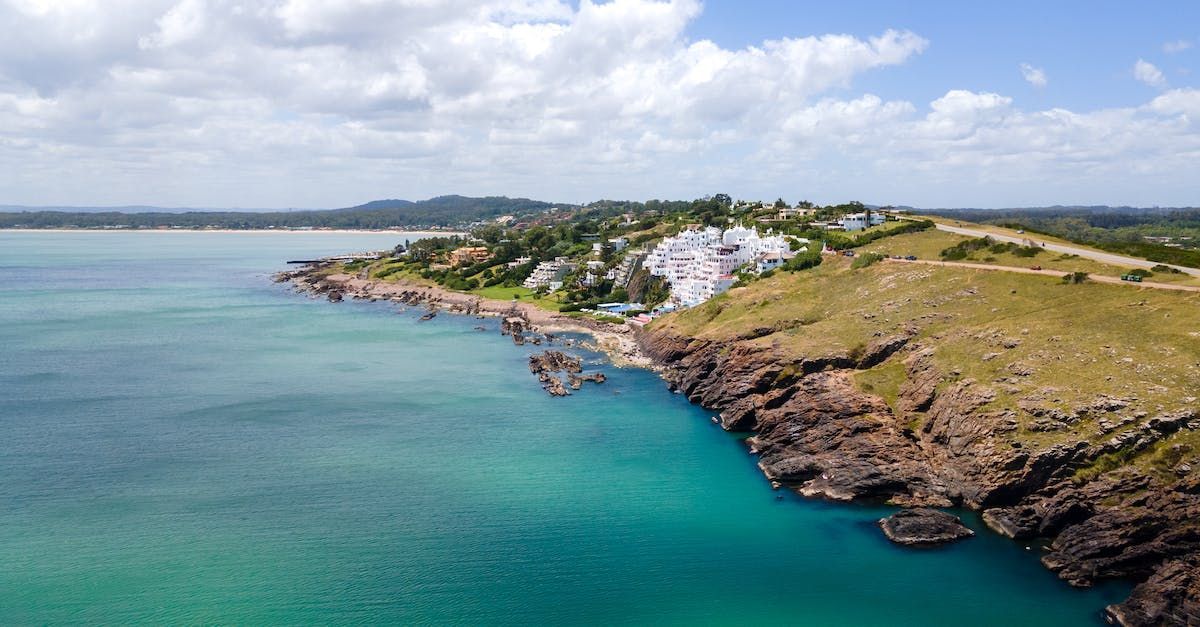 An aerial view of a cliff overlooking a body of water.