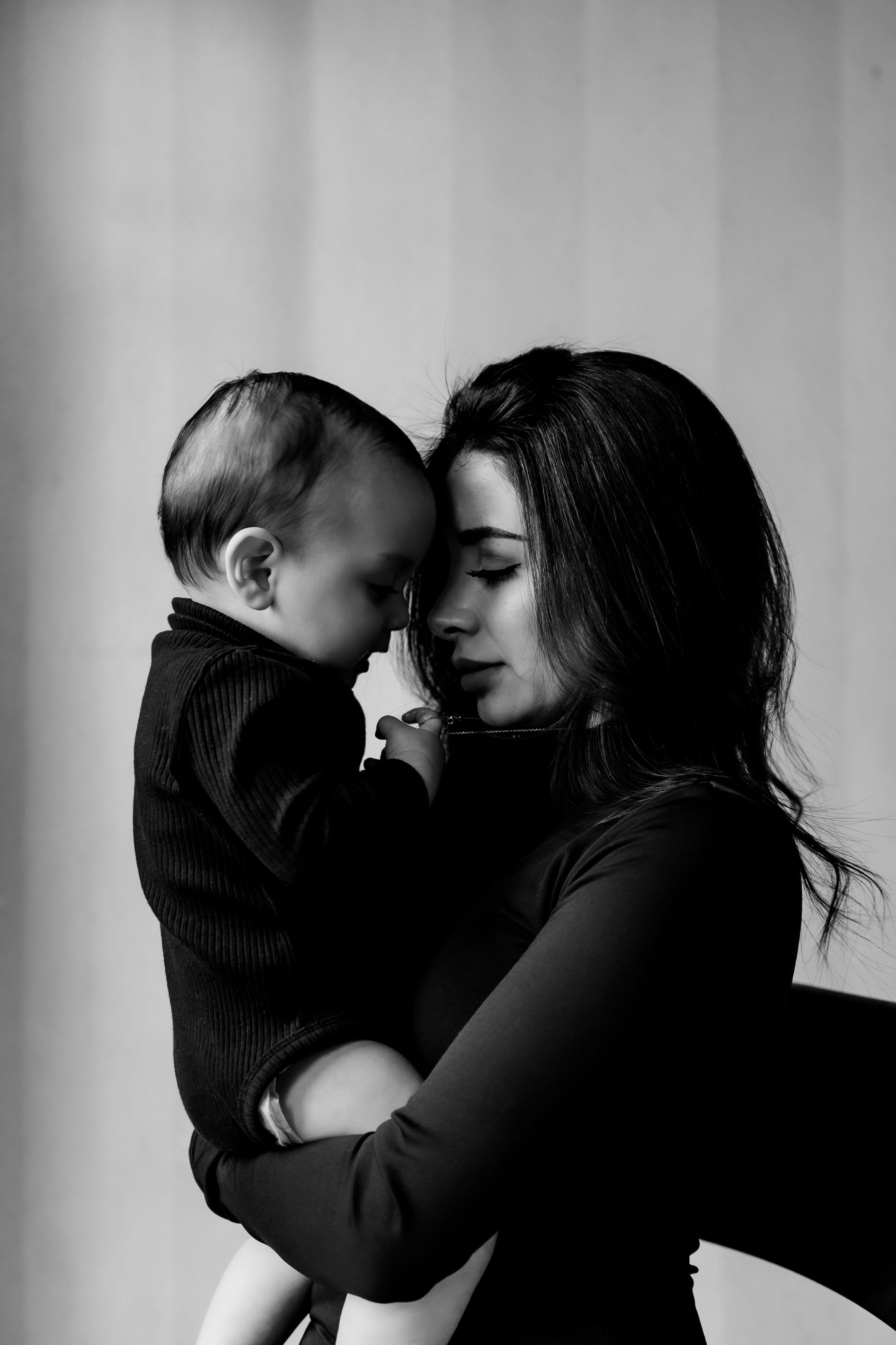 Mom and child touching head with each other