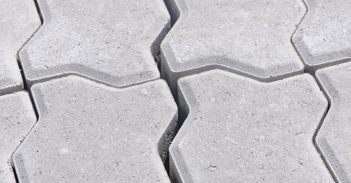 A close up of a row of concrete pavers on a sidewalk.