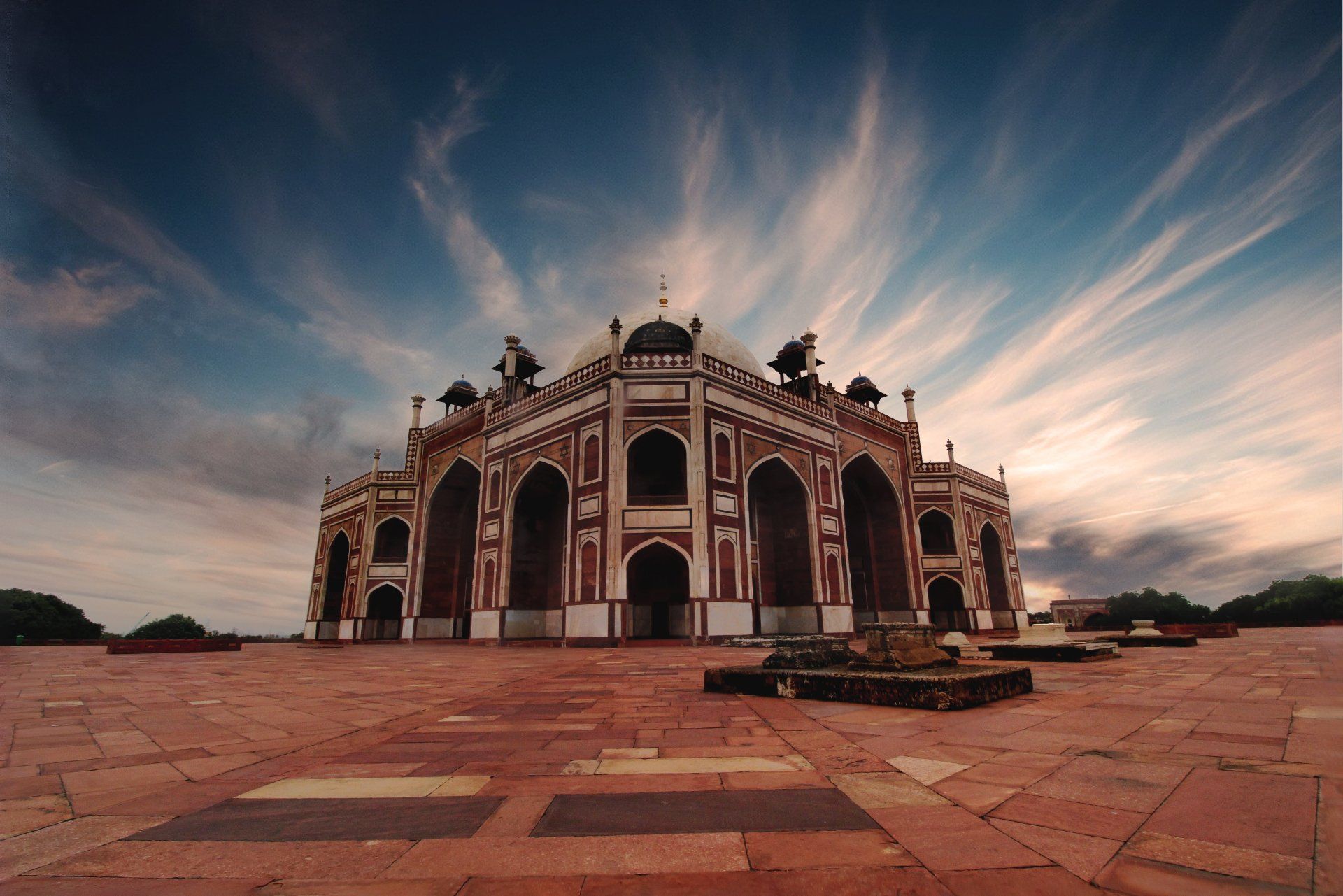 A large building with a cloudy sky in the background