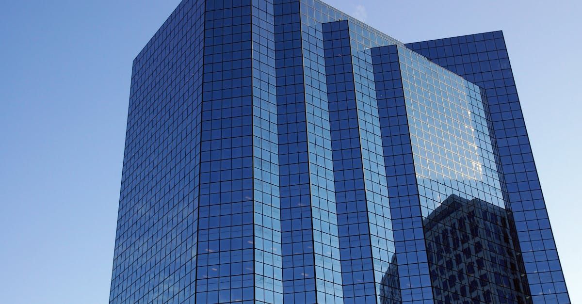 A tall blue building with a blue sky in the background