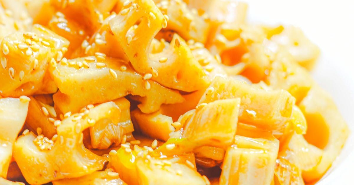 A close up of a bowl of macaroni and cheese with sesame seeds.