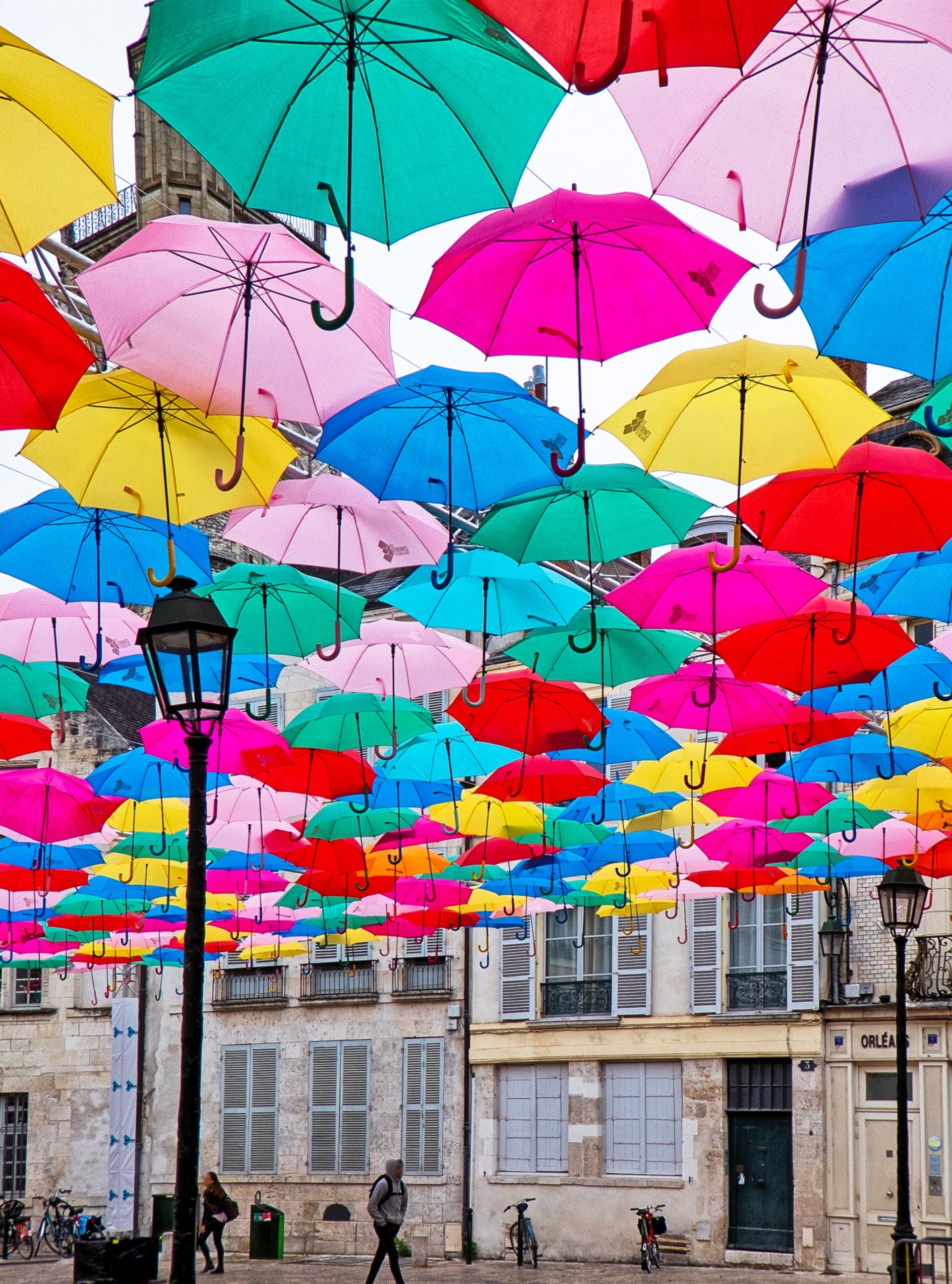 A bunch of colorful umbrellas are hanging from the ceiling