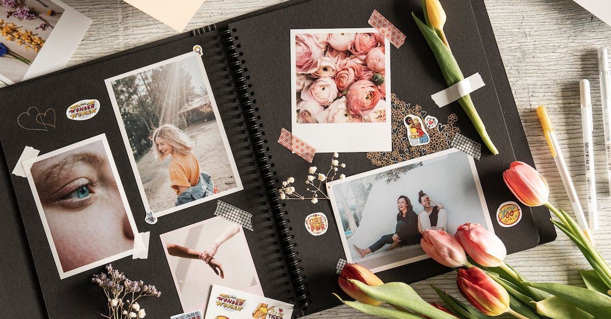 a photo album filled with pictures and flowers on a table .