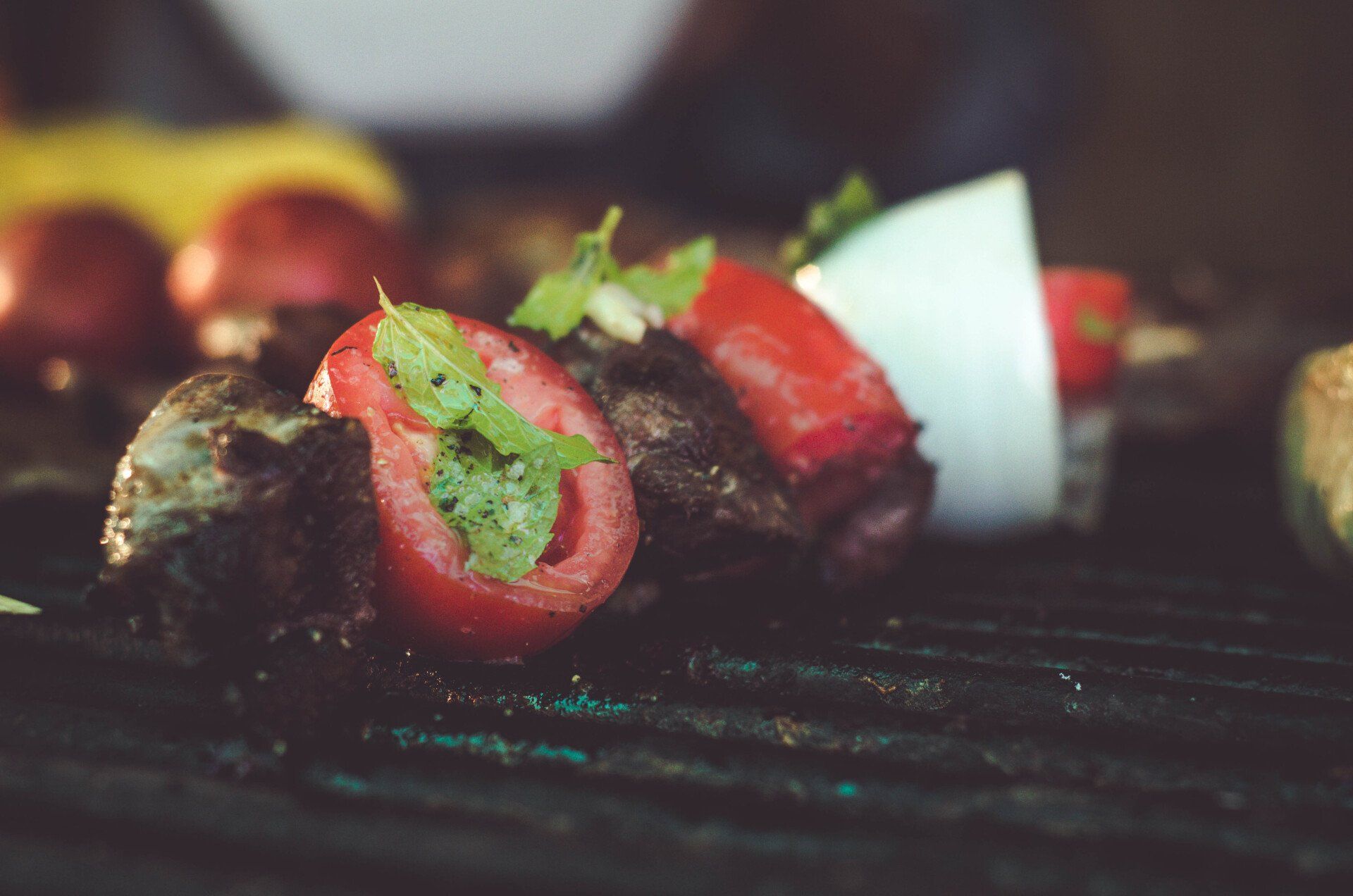 a close up of a grill with meat and vegetables on it .