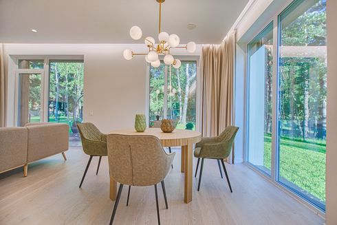 A dining room with a table and chairs and a chandelier.