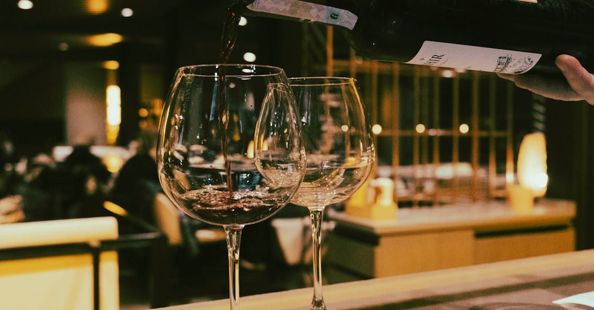 a row of wine glasses are lined up on a table .
