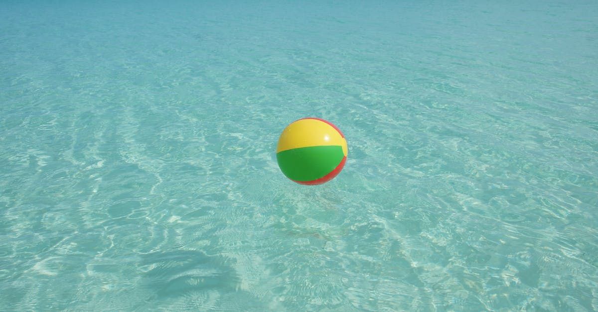 A colorful beach ball is floating in the ocean.