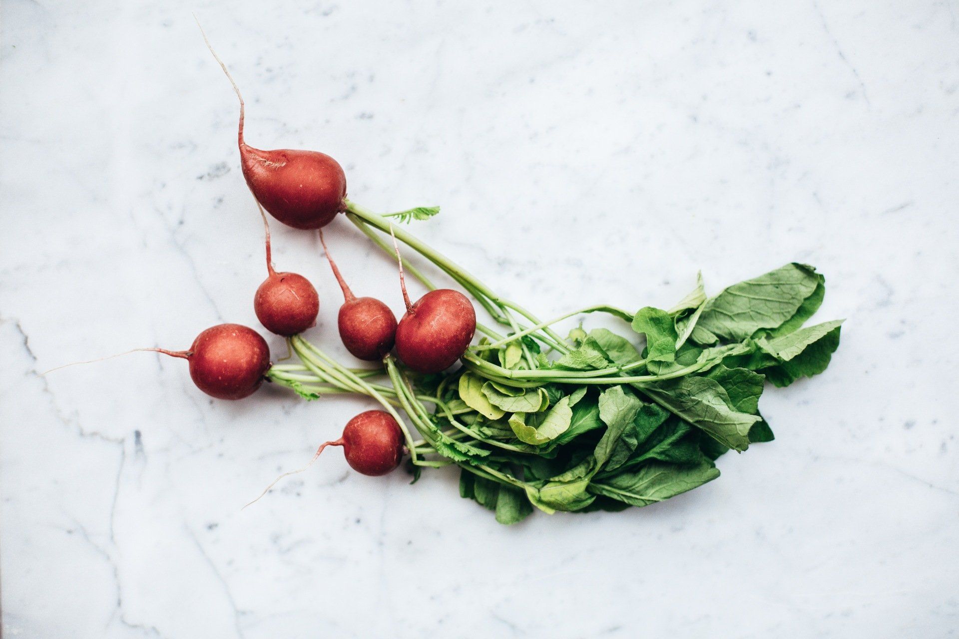 radishes on a white marble countertop