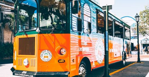 A colorful bus is parked on the side of the road.