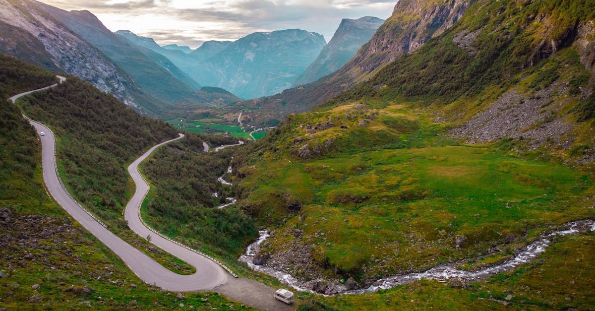 An aerial view of a winding road in the mountains.