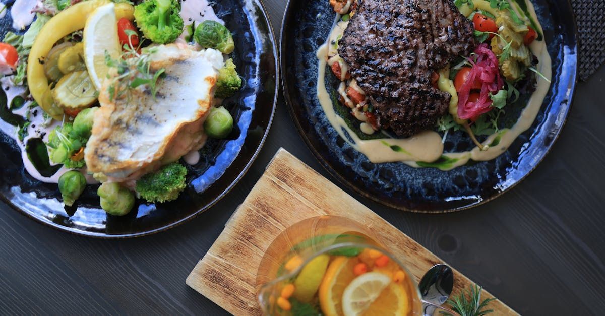 Three plates of food are sitting on a wooden table.