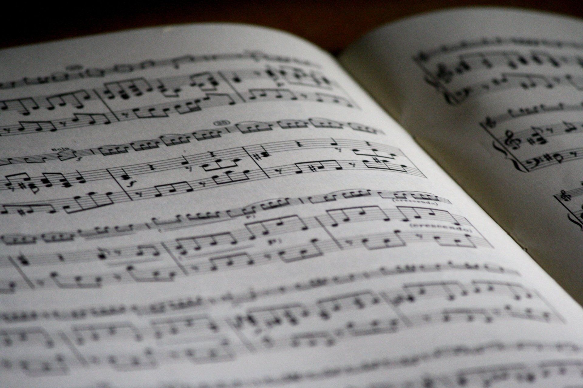 a close up of an open book with music notes on it
