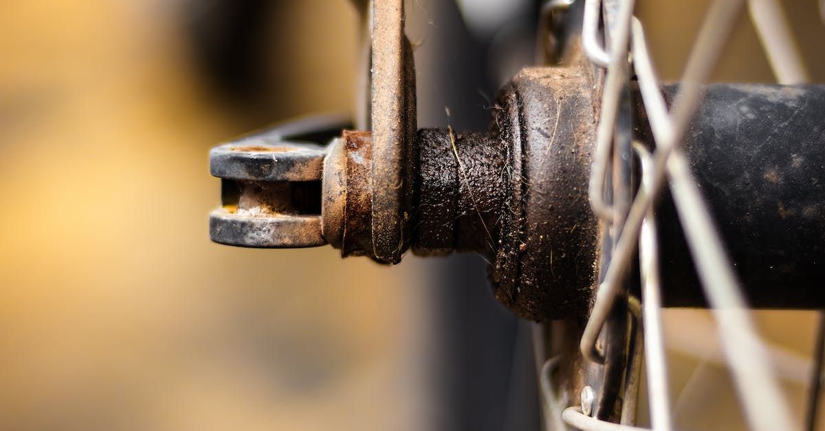 a close up of a bike wheel with rust on it